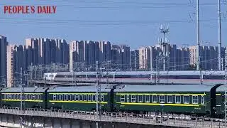 A meeting of three trains: both old-style trains and the Fuxing highspeed train in Qingdao