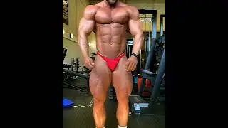 Delicious muscle god Ross Kerr flexing in Red posing trunks