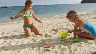 Children playing on the beach with toys 4k