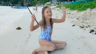 Evelina draws a Treasure Map in the sand on the beach