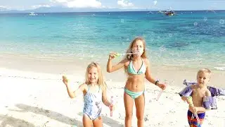 Children playing on the beach with soap bubbles 4k