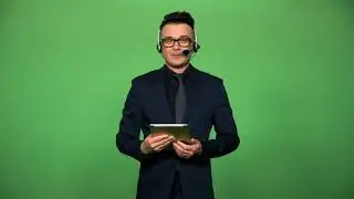 newscaster with tablet and headset speaking on green screen