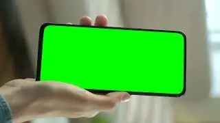 Hand showing a cellphone with a chroma key screen   Free Stock Video