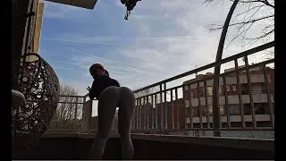 Flexible girl on the balcony