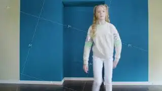 Young teen girl dancing rumba dance on training in blue studio. Female samba dancer showing dance in