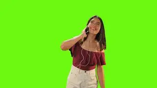 Girl dancing with her earphones on a green background   Free Stock Video