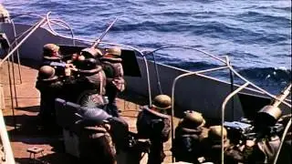 Three 20mm anti aircraft gun crew members fire a gun during the invasion of Norma...HD Stock Footage