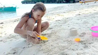 Children playing on the beach with sand 4K