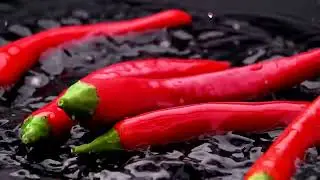 Red chili pepper falling into black water copyright free fruits and vegetables video