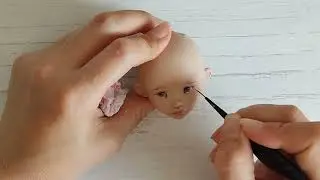 Роспись лица куклы.
