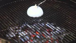 How to clean a grill using an onion and a fork