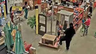 Man, woman, kids walk out with lawn mower from Home Depot