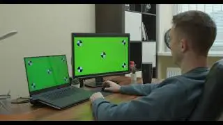 Man working on computer with green screen - Chroma Key - No Copyright