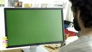 Man working on a computer with a green screen || no copyright || green screen