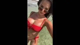 Sexy babe strutting in red bikini two piece. Wow!