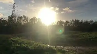 Brisk walk through an open field into the blazing sun