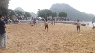 Boys playing football on the beach of Titop island, Halong Bay, Vietnam Incredible Land Tours