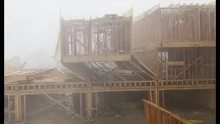 Watch as high winds and rain knock down several townhomes under construction in Dallas