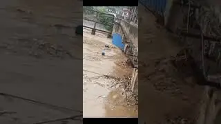 A house is washed away by floodwaters after heavy rain