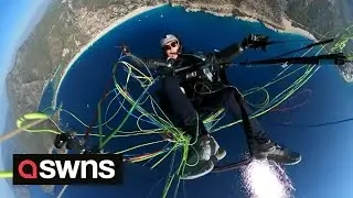 Terrifying moment paraglider plummets into FREEFALL after chute fails | SWNS