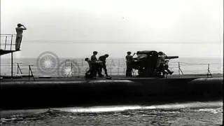 The 5-inch 25 Caliber gun on a submarine at sea is fired by the crew after surfac...HD Stock Footage