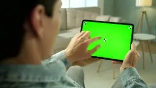 Rear view of green screen tablet swipe in living room   Free Stock Video