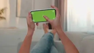 close up of the horizontal smartphone with chroma key and tracking motion on its screen in hands