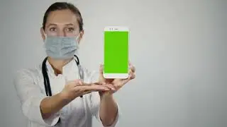 Female doctor displaying mobile with green screen   Free Stock Video