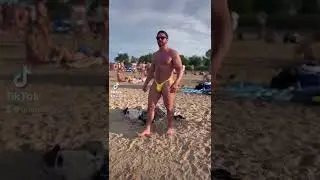 Muscle hunk Steve Grande walking on beach in yellow thong showing off big bulge