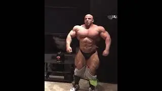 Bald muscle giant Big Ramy muscle posing in black underwear