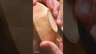 This man skillfully carved a small wooden bowl using only hand tools