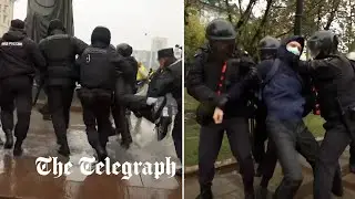 Russian police drag people into vans after they gathered to protest mobilisation of reservists