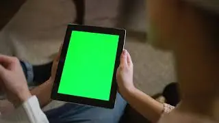 Couple watching together a tablet with green chroma   Free Stock Video