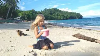 Amelia playing on the beach with sand