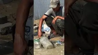 Palestinian children try to fill their bottles from leaking network pipes