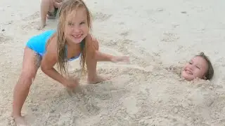 Children playing with sand on the beach. Nice joking 4k