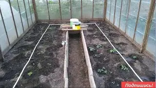 Automatic watering in the greenhouse. With a water timer. Drip irrigation.