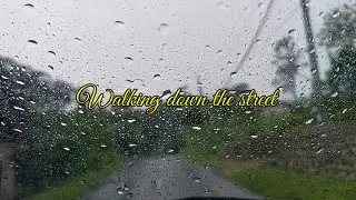 WALKING DOWN THE STREET IN THE RAIN