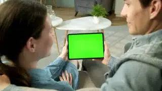 Back view of couple holding green screen tablet   Free Stock Video green background videos editing