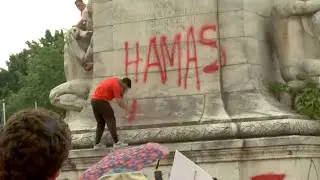 Protester sprays Hamas is comin on Christopher Columbus statue in Washington, D.C.