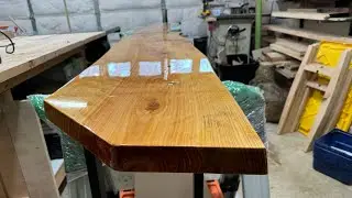 Pouring a layer of table top epoxy on a live edge slab