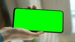 Hand showing a cellphone with a chroma key screen||green screen || NO COPYRIGHT