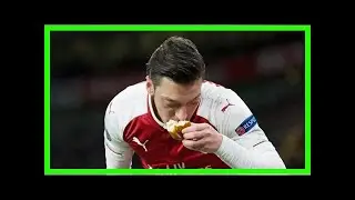 German Muslim footballer Mesut Ozil kisses bread thrown at him by Atletico Madrid fans