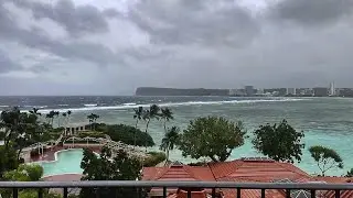 Rain and winds lash Guam as Typhoon Mawar closes in and residents shelter