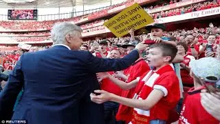 Arsene Wenger gives his tie to lucky young Arsenal fan during lap of honour to celebrate 22-year